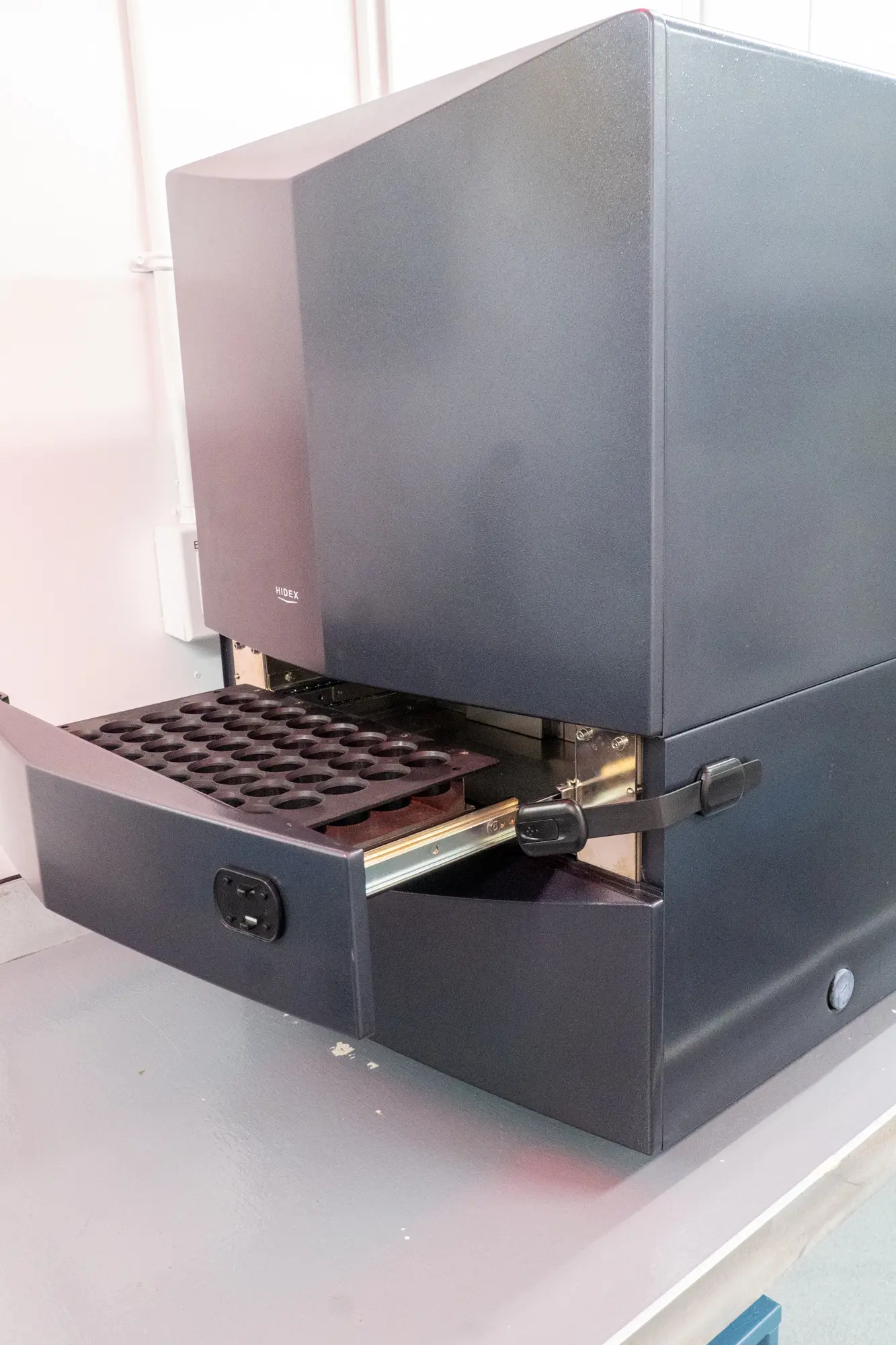 A black Hidex with its drawer open.