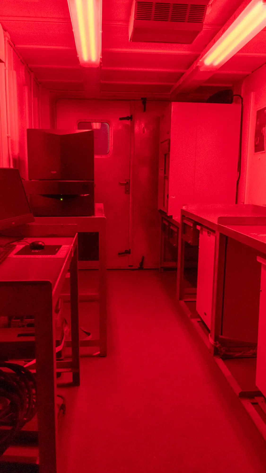 The interior of a lab van with red lighting.