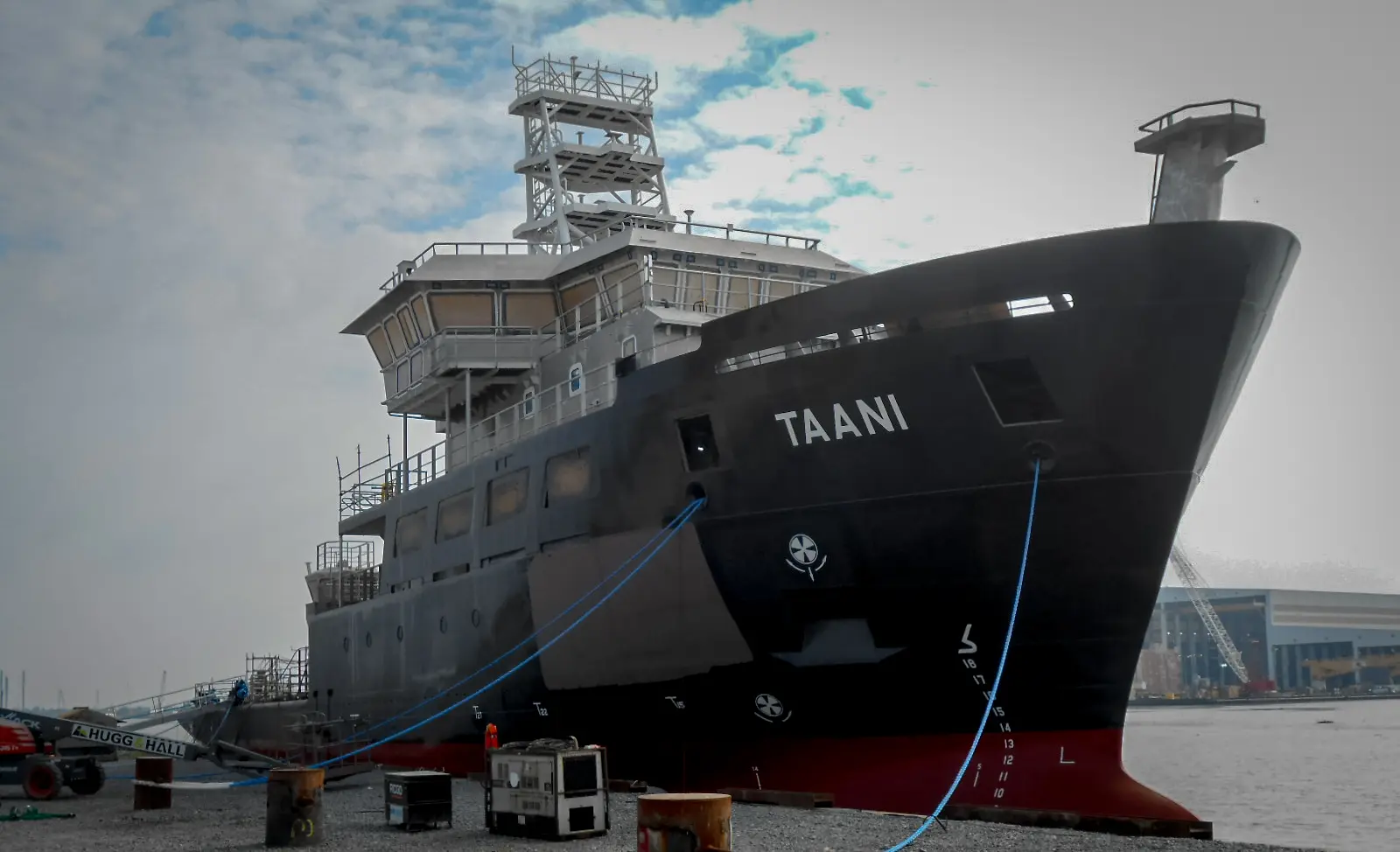 A large research vessel, the R/V Taani, at a dock.