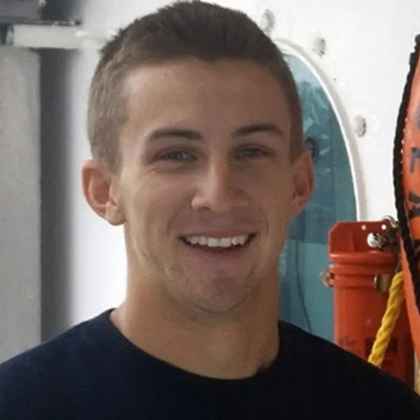 A person smiles at the camera.